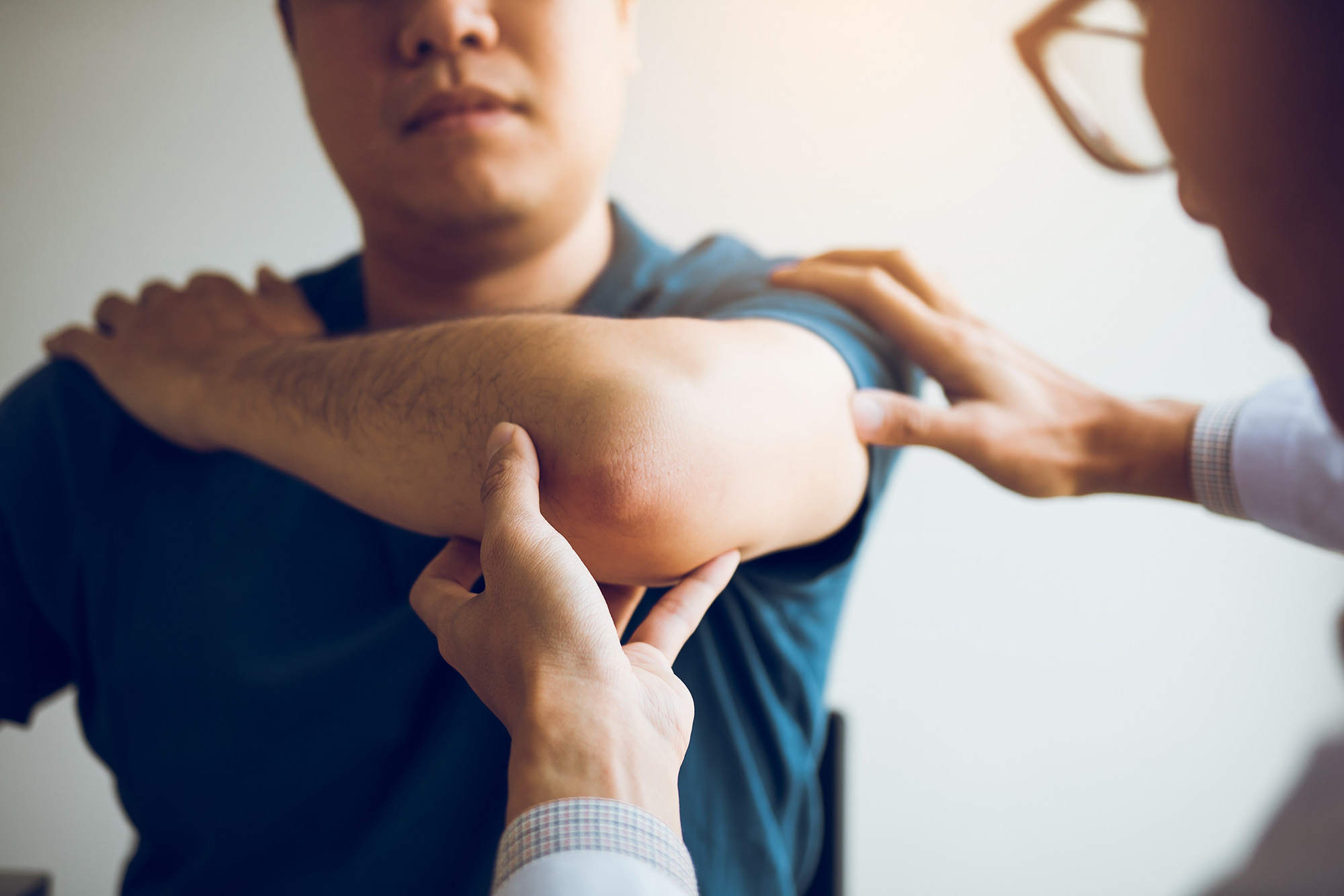 physical therapist trains shoulder mobility with patient